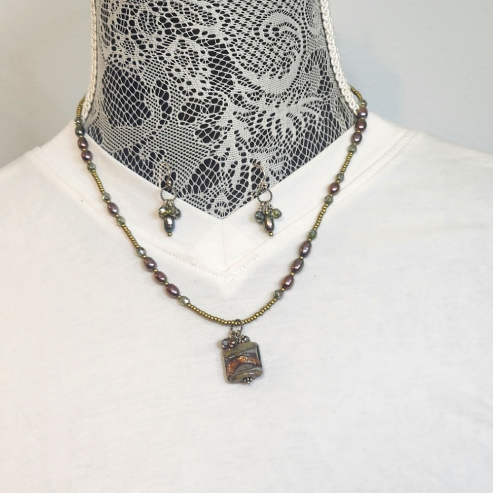 Artisian handmade beaded necklace with matching earrings.